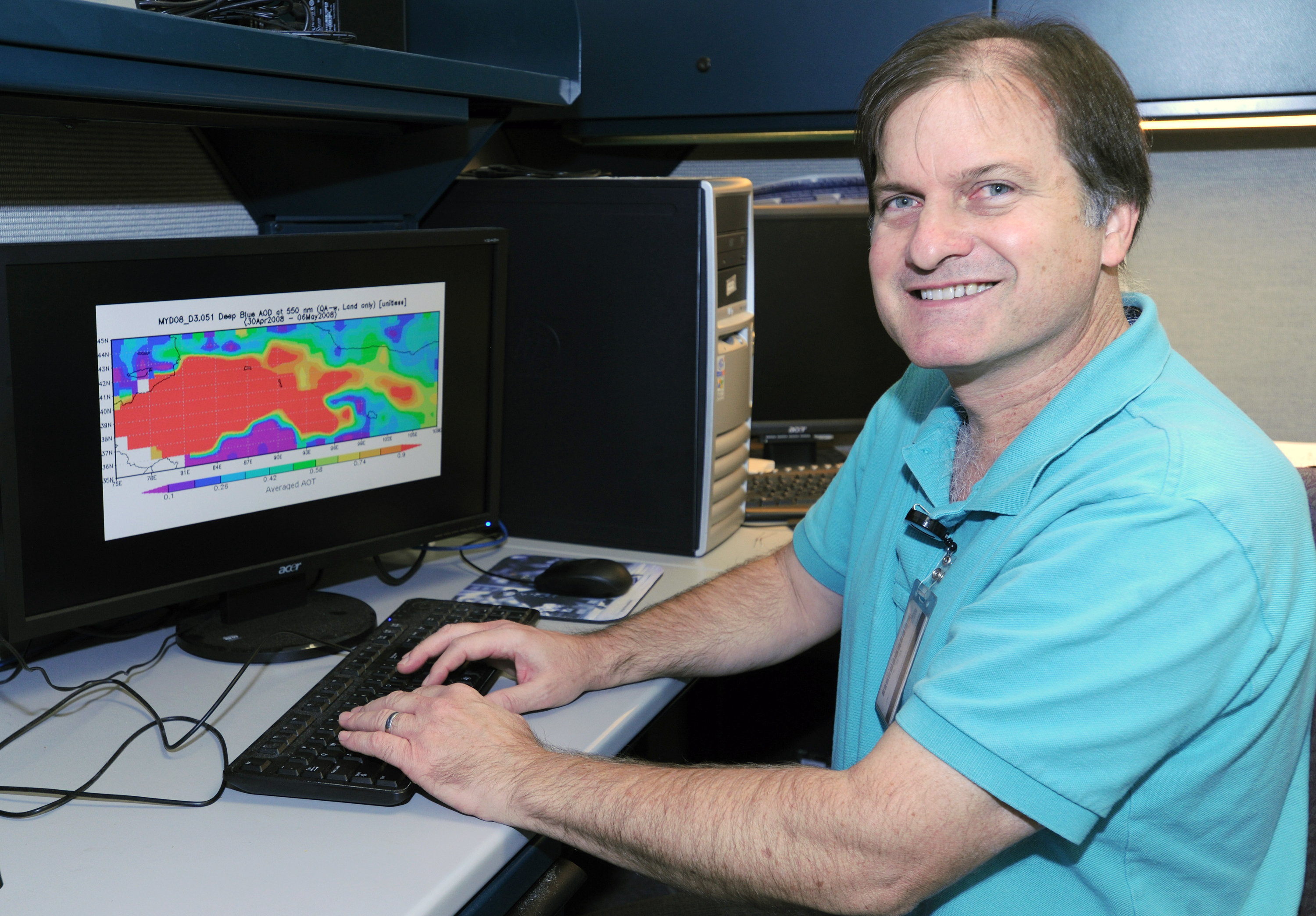 Atmospheric scientist Richard Hansell works with data that show the location of a spring 2008 dust event (red) measured in Zhangye, China, between the Taklimakan and Gobi deserts. Credit: NASA/Goddard