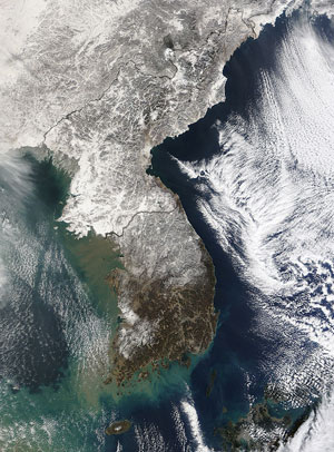 Korean Peninsula: On the other side of the world, Arctic weather was also brought to bear on the Korean Peninsula. This image was taken on Jan. 3, 2010. Scientists say this year's severe winter weather is still to be expected from time to time, even as increased concentrations of man-made greenhouse gases create a long-term warming trend for the planet. 
Image courtesy of NASA, MODIS Rapid Response