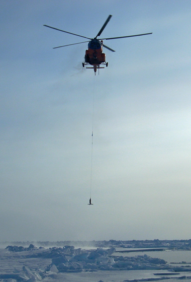 An instrument about to be dropped through an opening in the ice to the seafloor will record ocean bottom pressure to compare with similar data recorded by NASA's GRACE satellites. Data from GRACE, ICESat and actual water samples led to the discovery of a new pathway of freshwater in the Arctic. Credit: C. Peralta-Ferriz/UW Applied Physics Laboratory