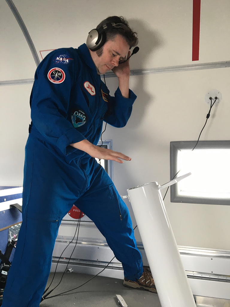 Josh Willis after releasing an ocean probe down the white tube, where it drops from the plane into the ocean.