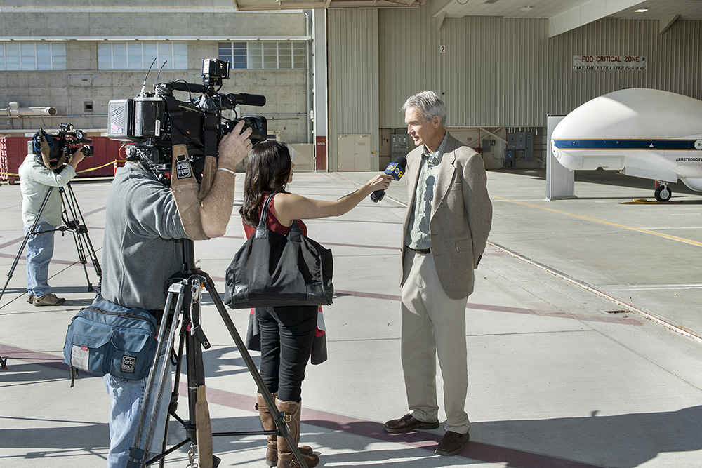 Frank Cutler, NASA Armstrong's Global Hawk project manager, talks to media about the Global Hawk and its current mission. Credit: NASA Photo/Ken Ulbrich.