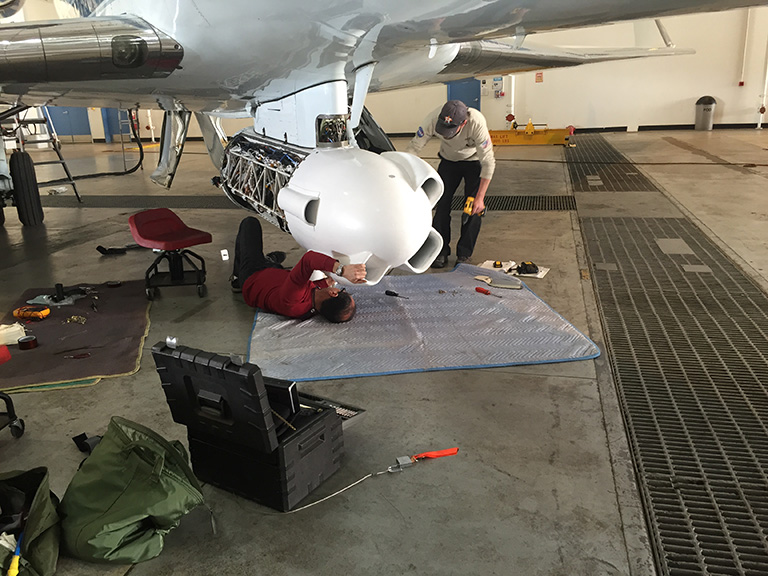 NASA technicians put the final touches on the GLISTIN-A instrument.