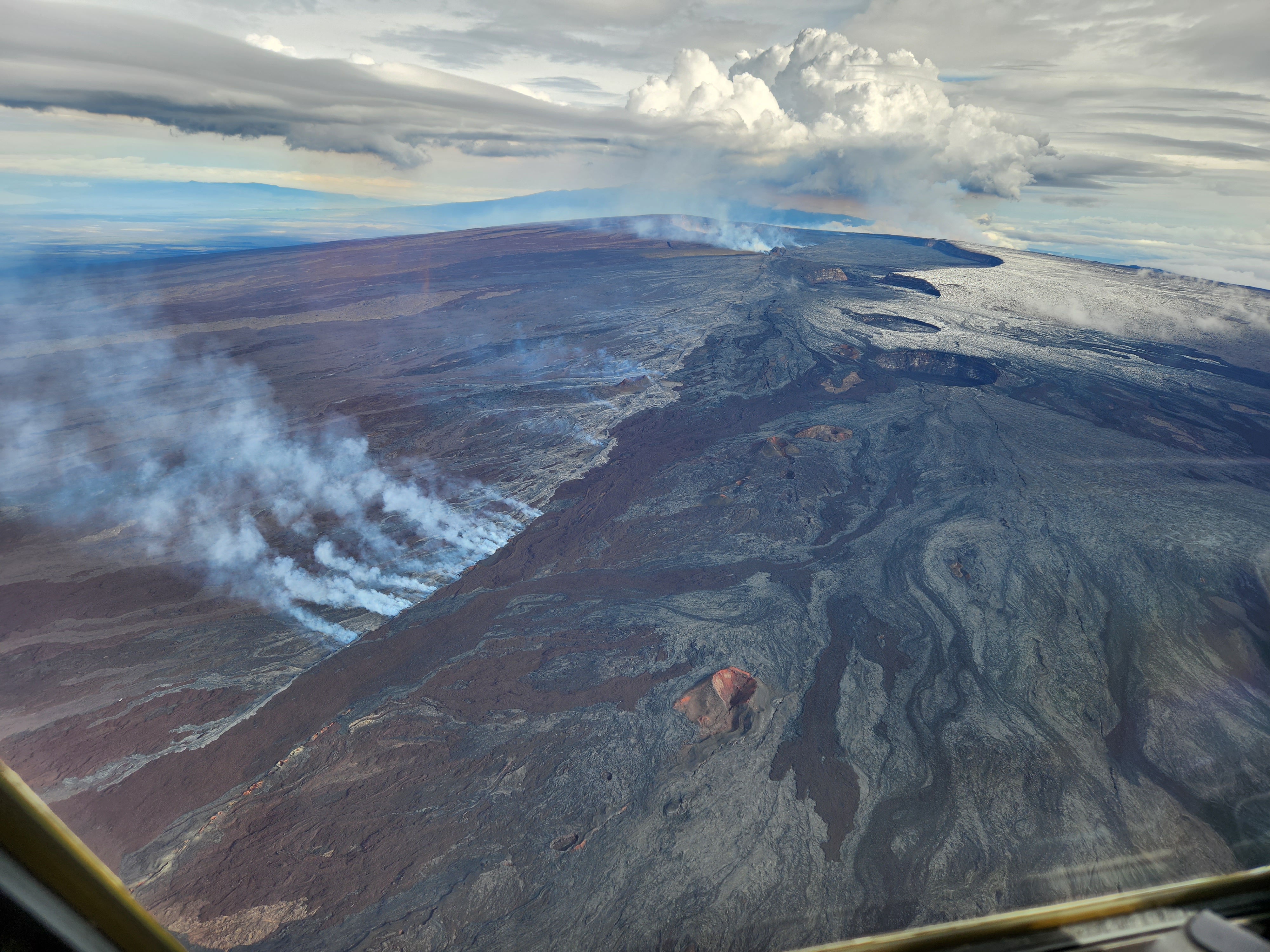 Aerial view of recent lava flows near Mauna Loa’s summit in November 2022. The National Oceanic and Atmospheric Administration (NOAA) monitors greenhouse gases at Mauna Loa Observatory, which is 4 miles (6 kilometers) away from the summit crater. Despite the proximity, volcanic gases aren’t common at the observatory, and when they do happen, these temporary spikes are not included in the long-term data. The decades-long trend of increasing CO2 at Mauna Loa matches that from sampling sites all around the world. Credit: USGS/J. Schmith
