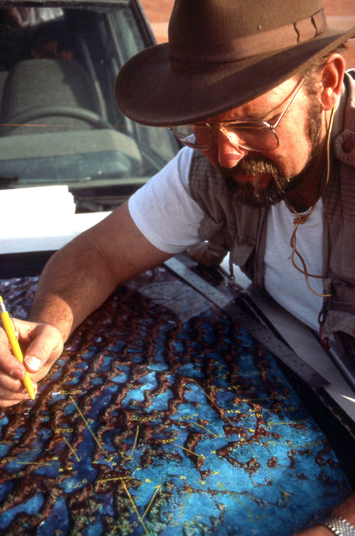 Dr. Ron Blom uses satellite imagery to help navigate through sand dunes in the desert of Oman. Credit: Nicholas Clapp.